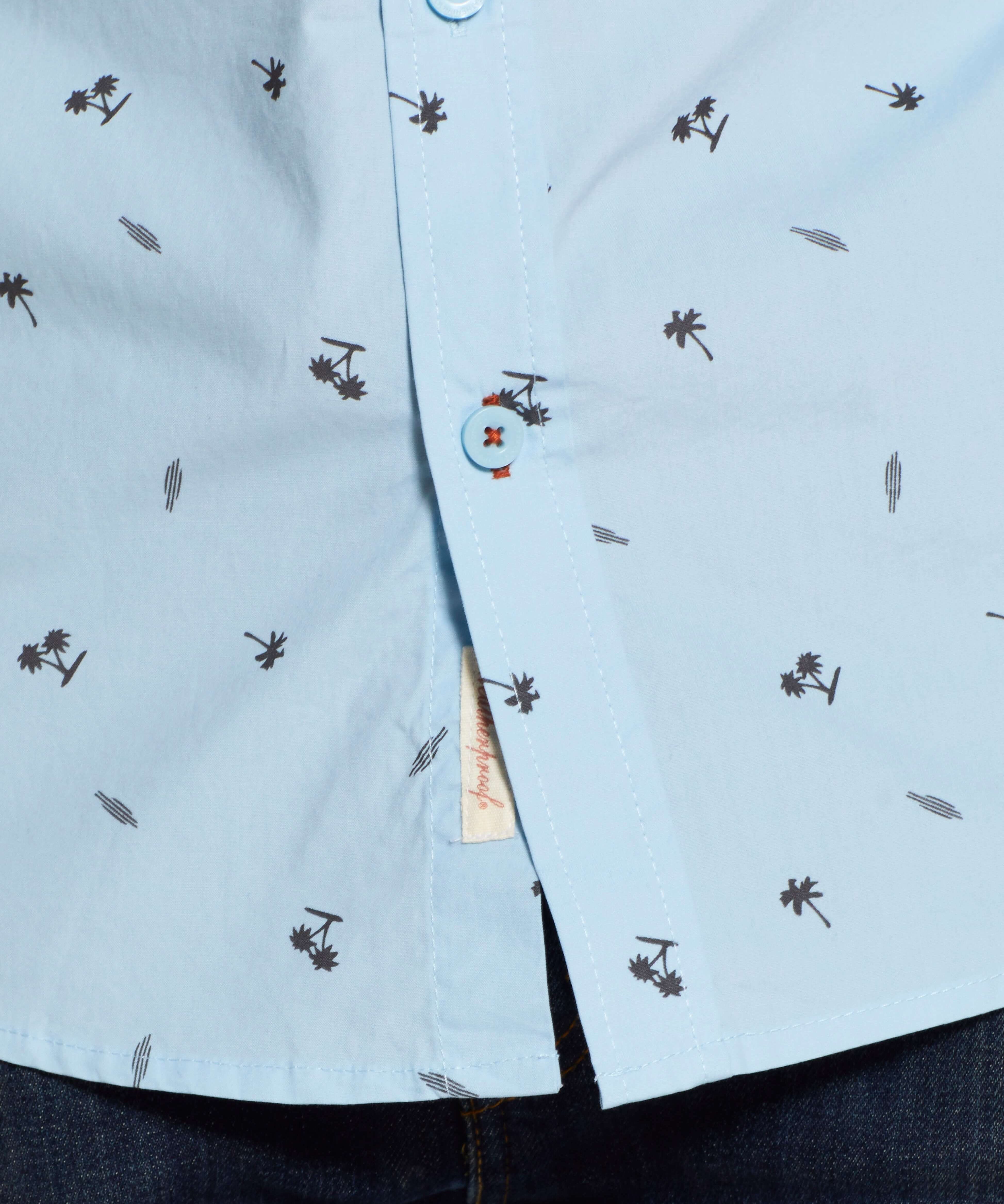Peached Poplin Mini Print In Soft Blue shirt featuring palm tree print and front button detail.