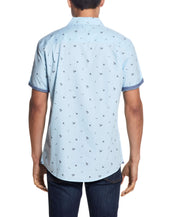 Back view of a man wearing a Peached Poplin Mini Print In Soft Blue shirt with short sleeves.