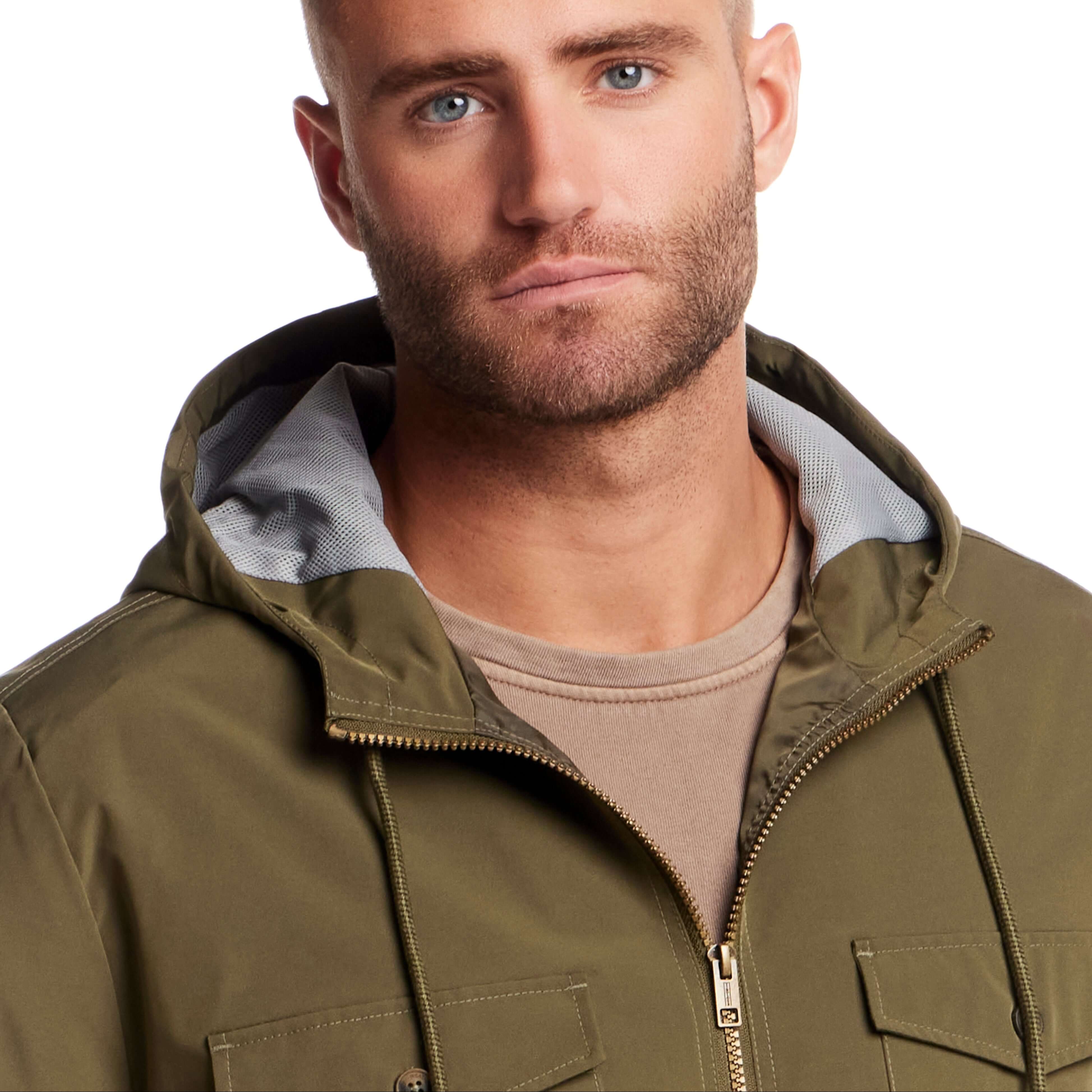 Close-up of a man wearing a Poly Memory Safari Jacket in Winter Moss with a hood, showcasing the zip front and chest pockets.