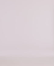 Minimalistic backdrop for product photography featuring soft, neutral tones, ideal for showcasing apparel.