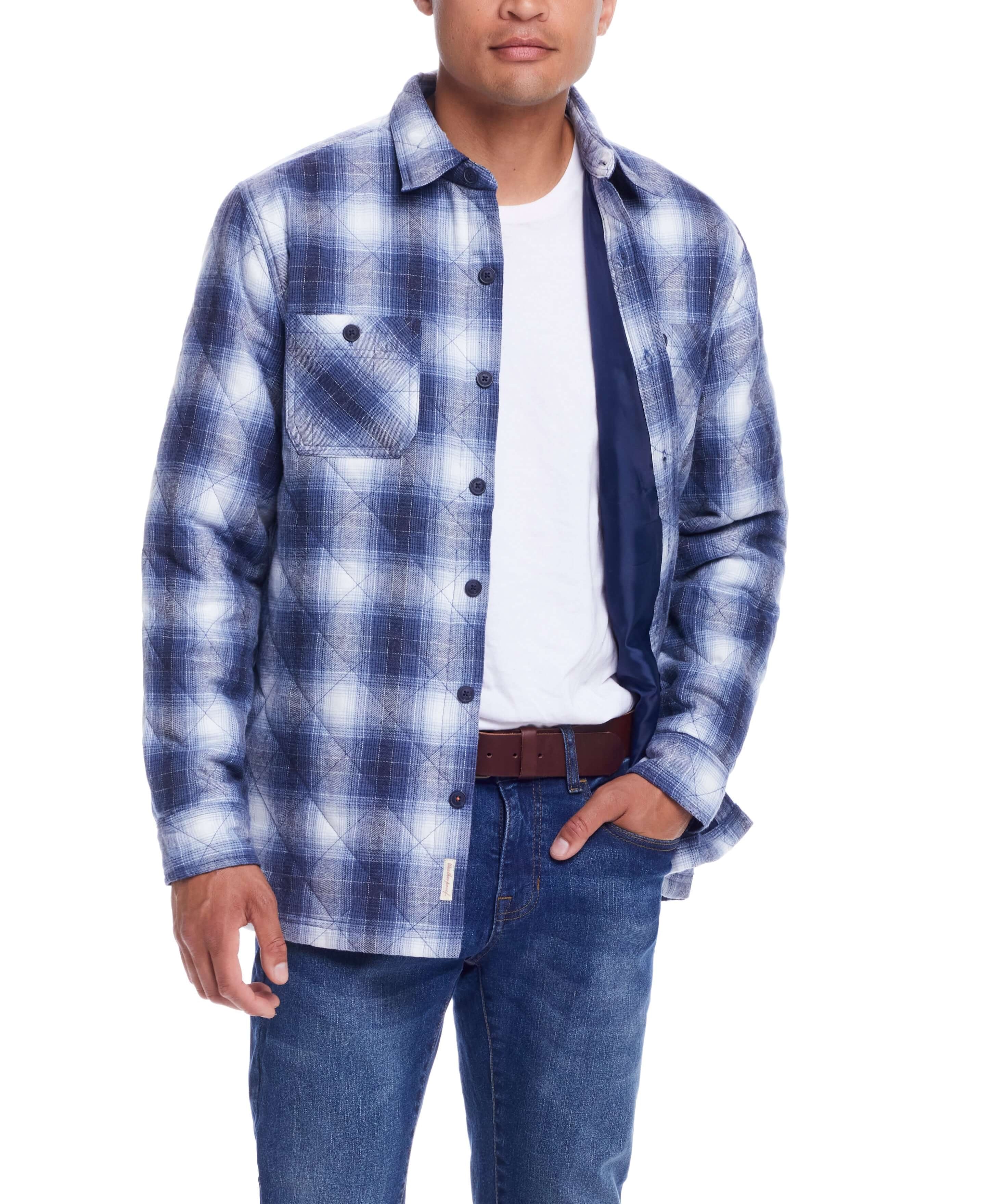 Man wearing a quilted plaid shirt jacket in Quiet Harbor, showcasing its stylish design and cozy comfort.