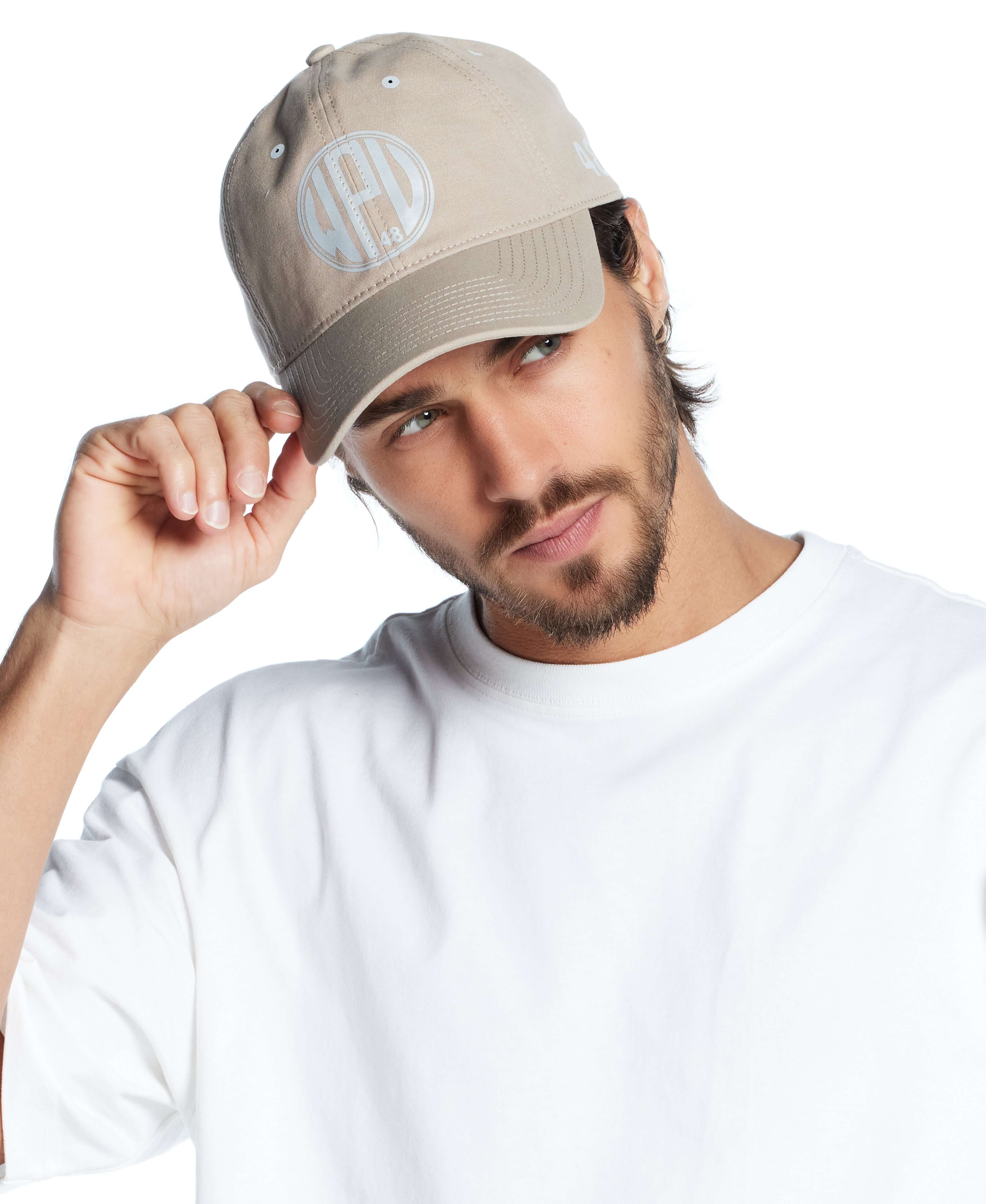 Reflective graphic hat in khaki, adjustable fit on a model, perfect for casual style and outdoor activities.