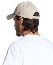 Reflective graphic hat in khaki, adjustable fit shown on a model from behind, perfect for casual outings.