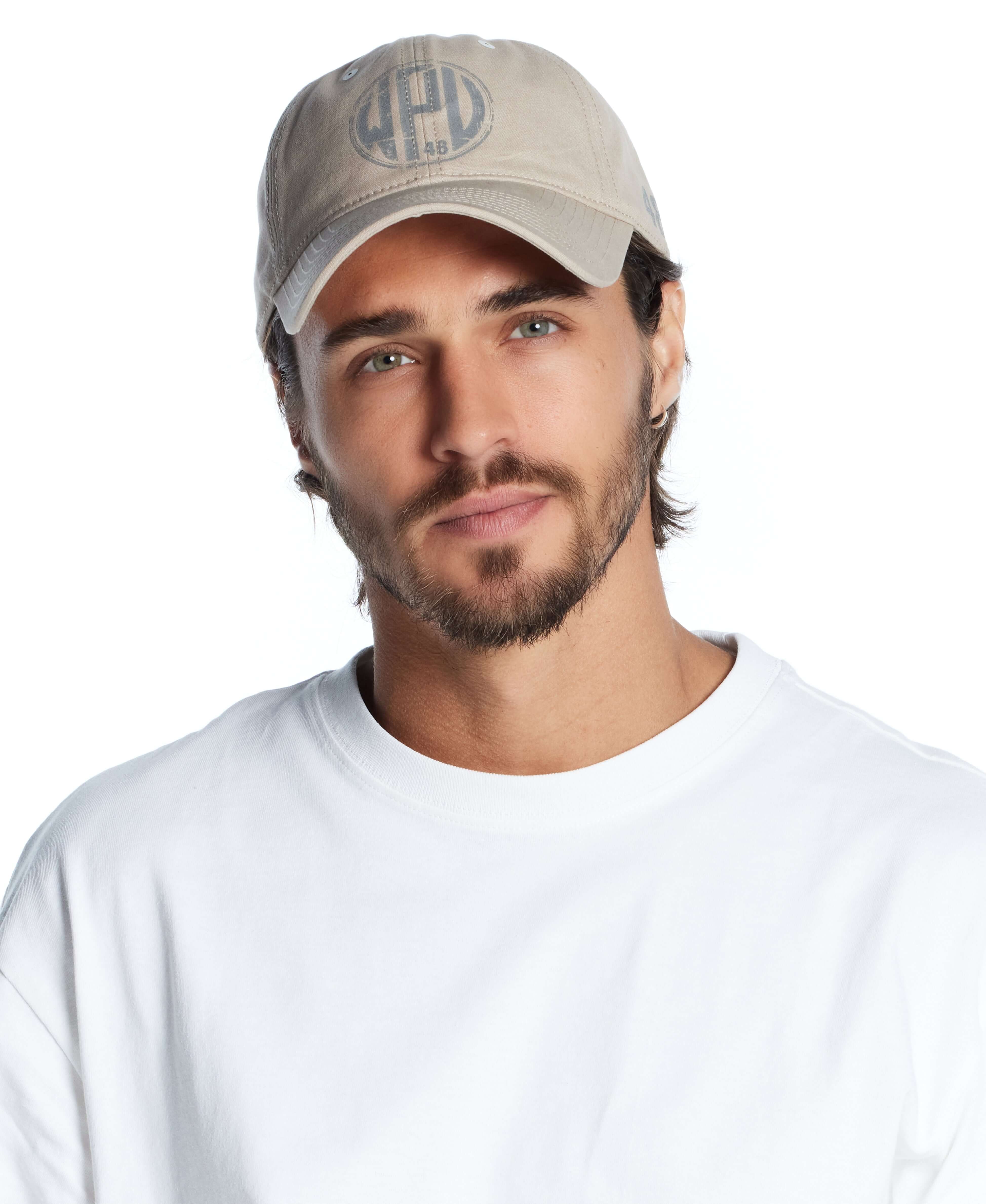 Man wearing a khaki adjustable reflective graphic hat, showcasing a stylish design perfect for casual outings.