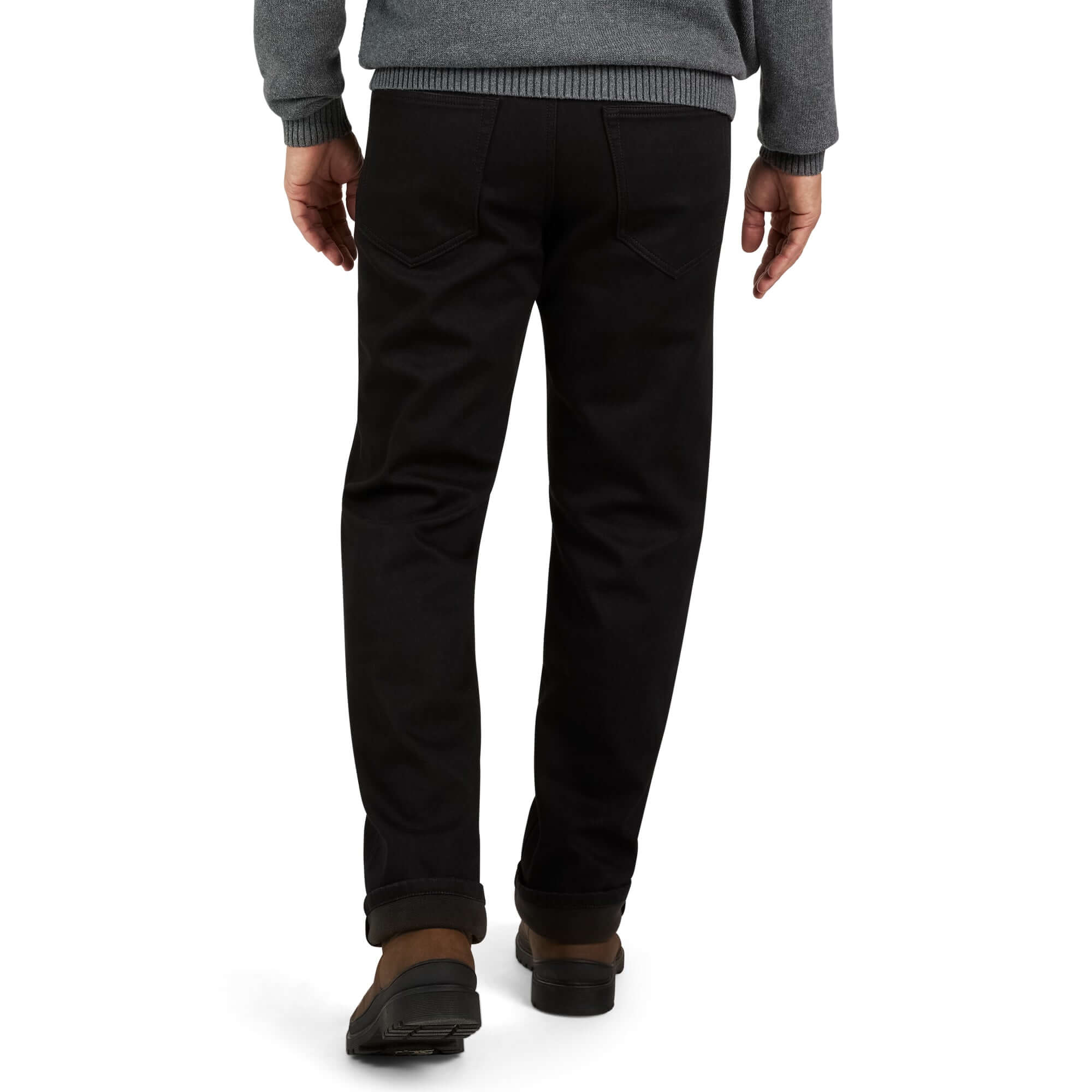 Man in regular fit fleece lined jeans in jet black, showcasing a cozy, stylish look for fall and winter comfort.