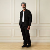 Model wearing a Ribbed Bomber Jacket in Black with matching pants, showcasing a relaxed style.