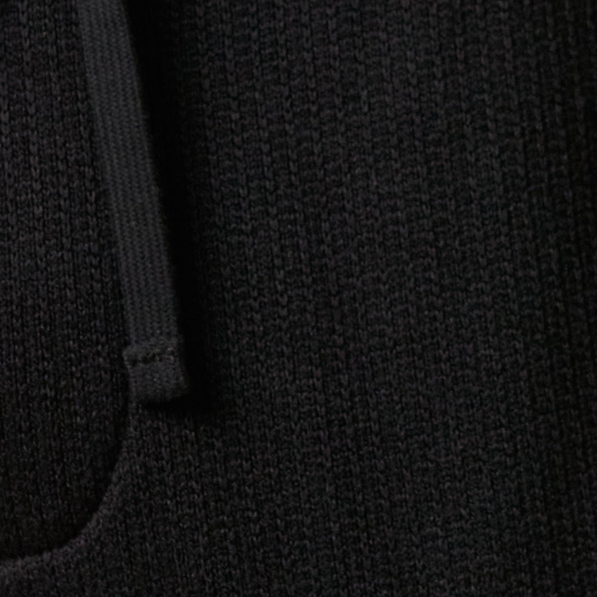 Close-up of the ribbed texture and drawstring waistband of the Ribbed Drawstring Pant in Black.