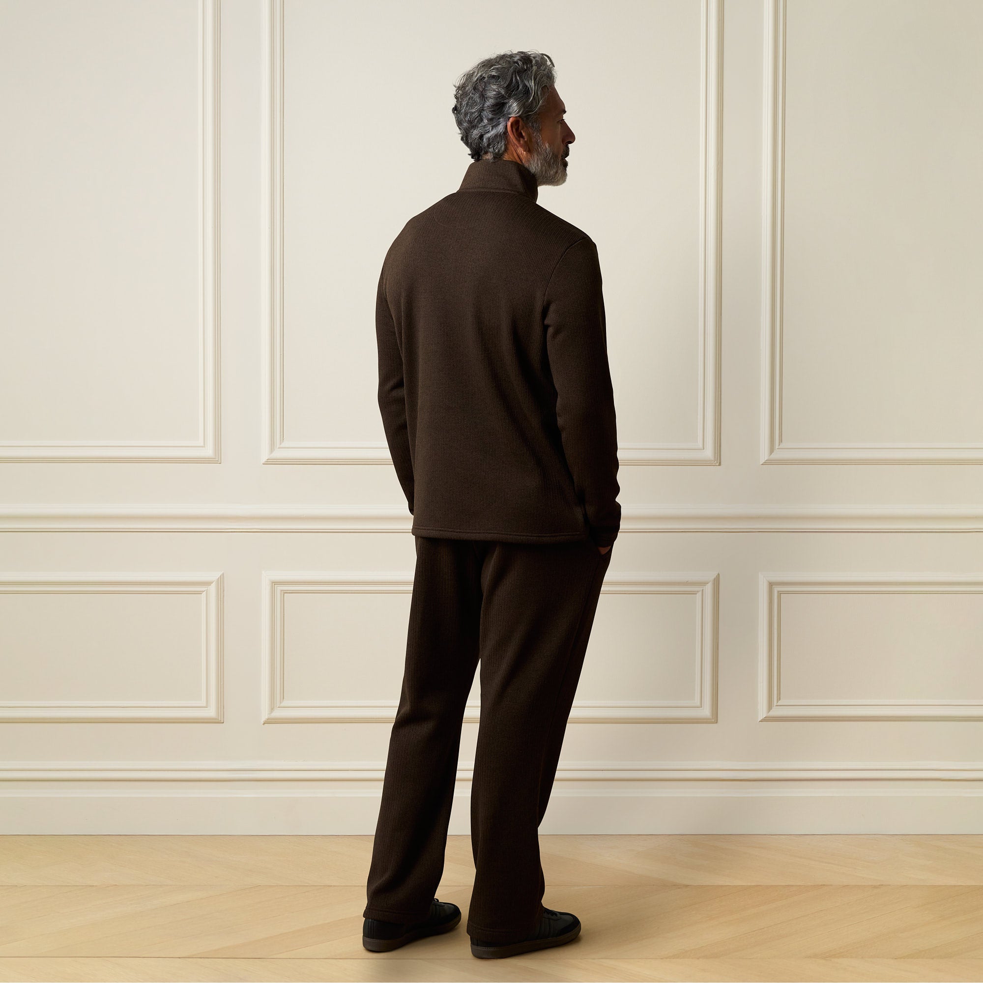 Ribbed Quarter Zip in Brown, back view of a man wearing a quarter-zip sweater and matching pants.