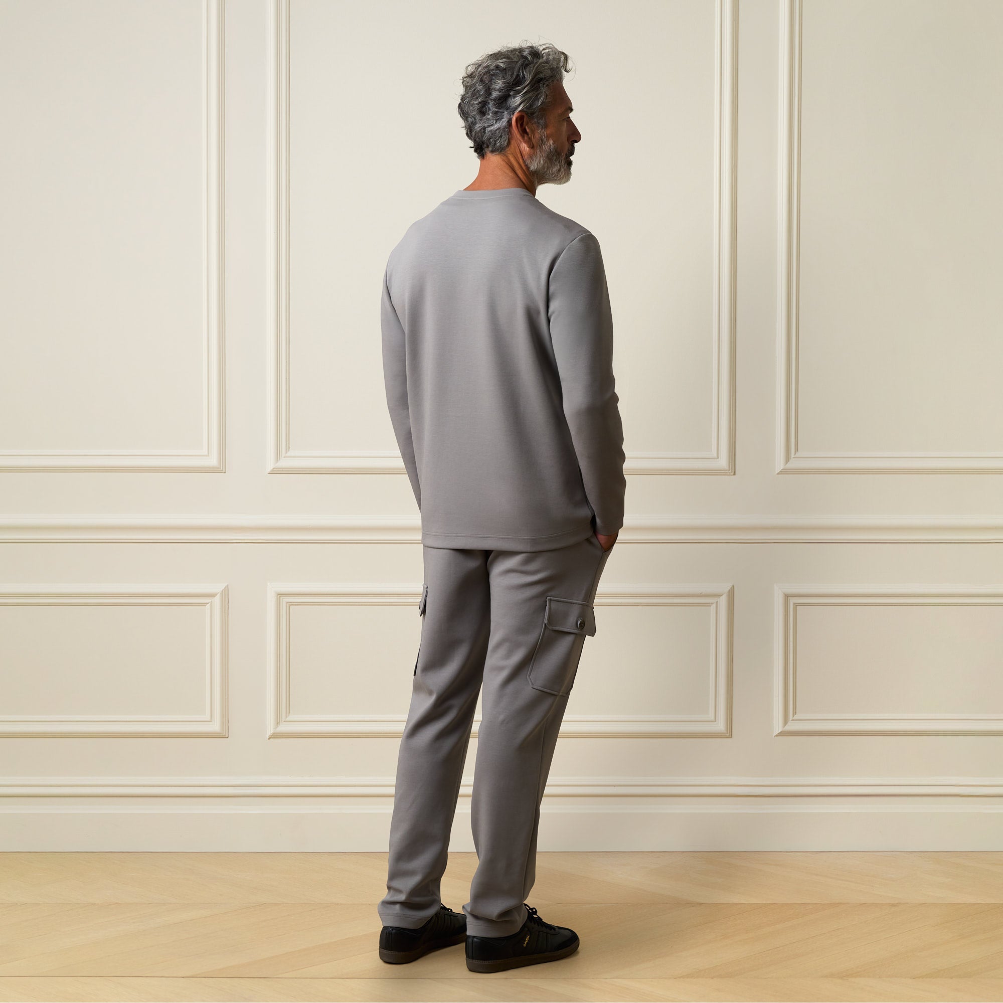 Scuba Cargo Jogger in Grey worn by a man from the back, showcasing its soft fabric and modern design.