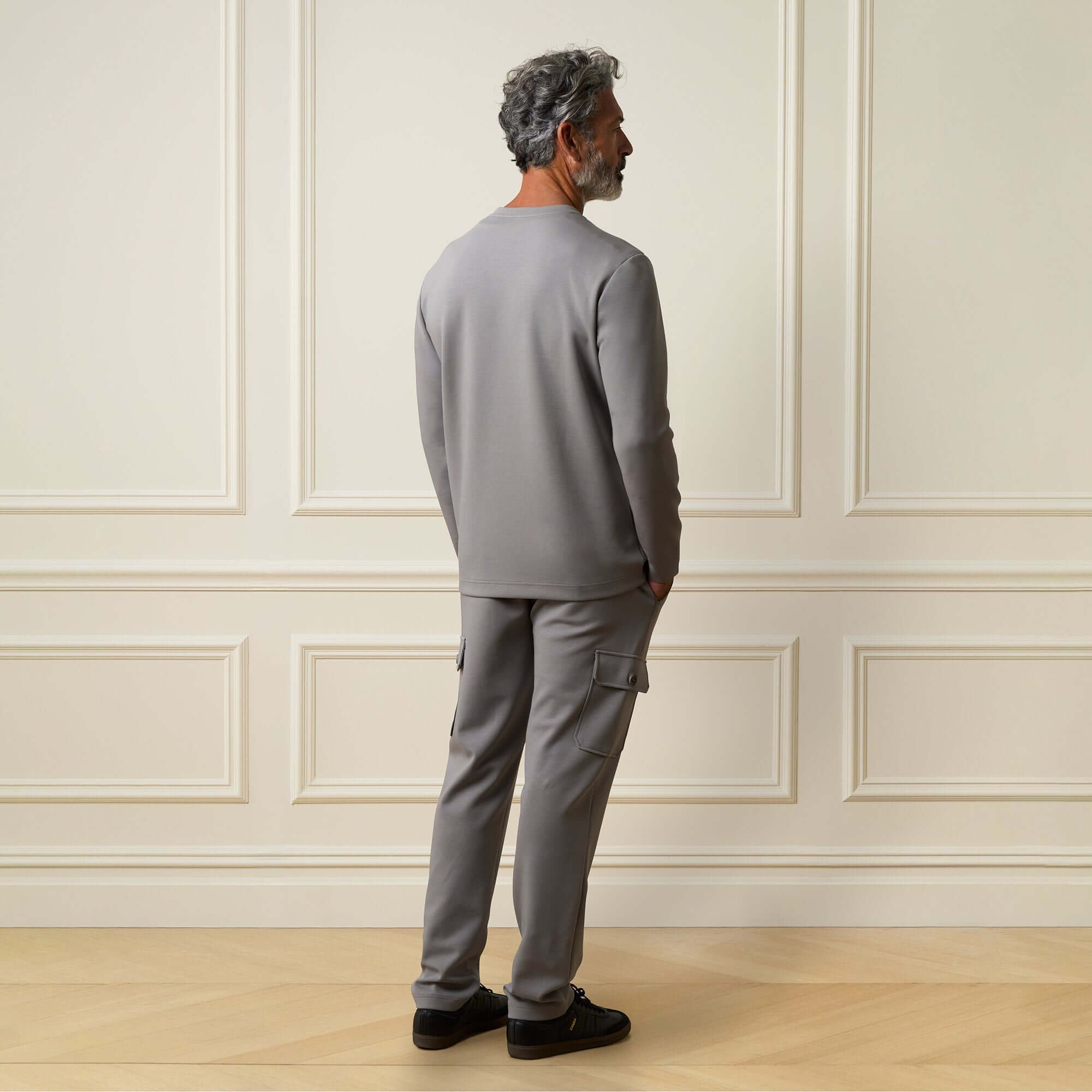 Scuba Crew Neck in Grey worn by a model from the back, showcasing smooth scuba knit fabric and modern design.