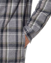 Close-up of a person wearing a Sherpa lined flannel shirt jacket in Twine, featuring a plaid design and side pocket.