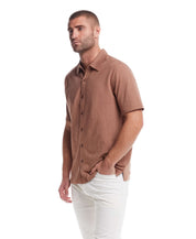 Short sleeve coat front knit in biscuit color, featuring button front and mini jacquard checkerboard pattern.