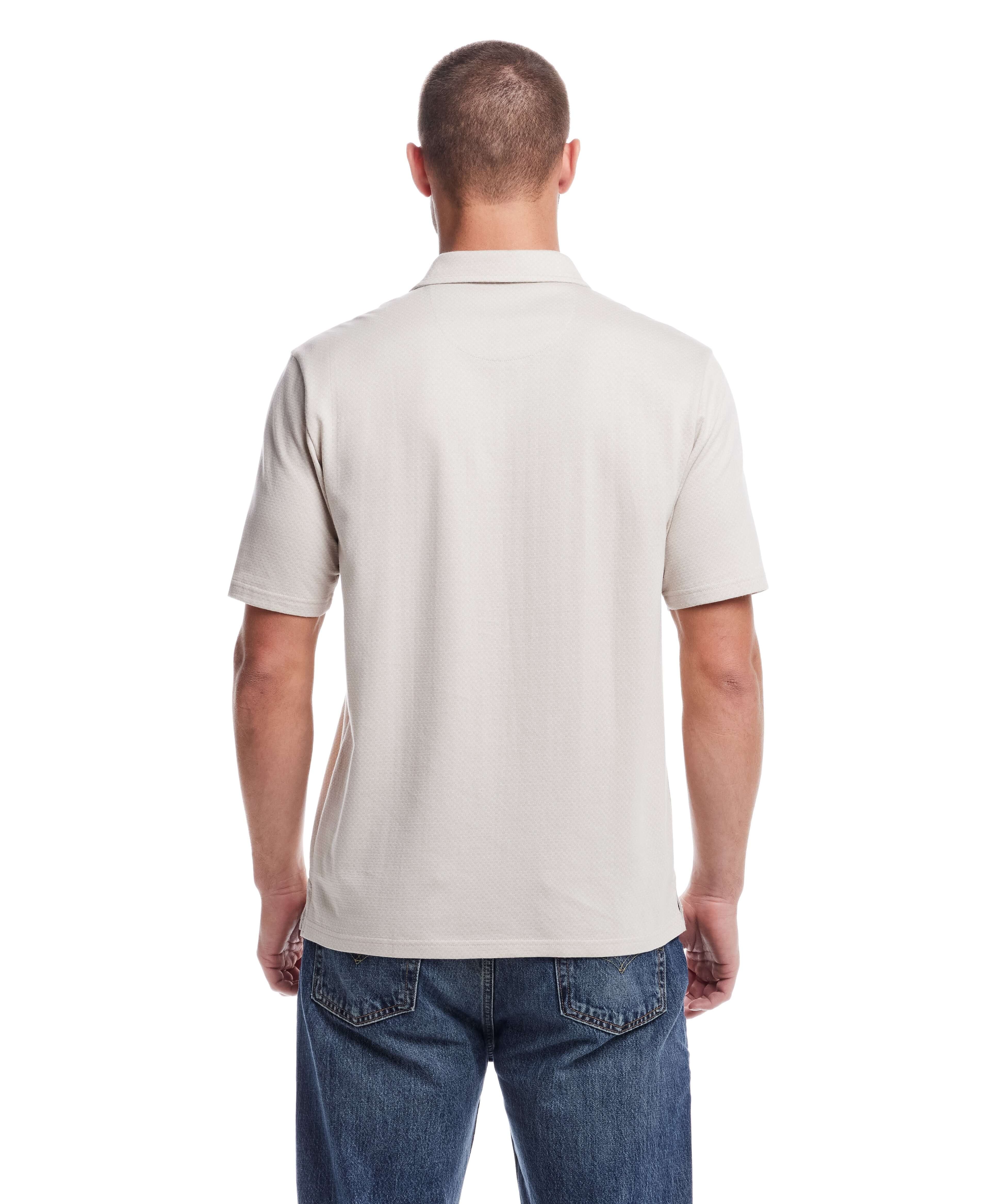 Back view of a man wearing a short sleeve button front coat in natural color, showcasing the minimalist design.