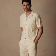Short sleeve corduroy cabana shirt in cream, styled with matching shorts, ideal for beach and vacation.