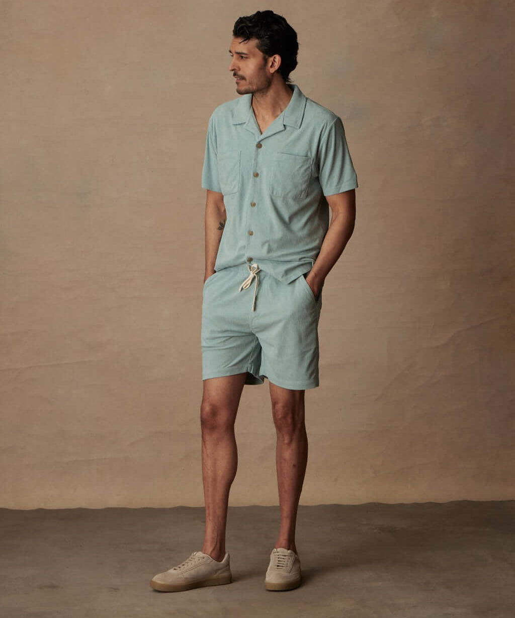 Model wearing Short Sleeve Corduroy Cabana Shirt and matching shorts in Teal Mist, perfect for beach vacations.