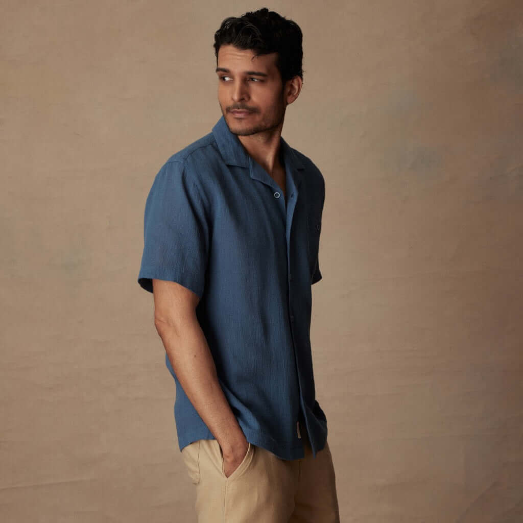 Short Sleeve Cotton Linen Airtex Shirt in Blue Ashes modeled by a man against a neutral background.