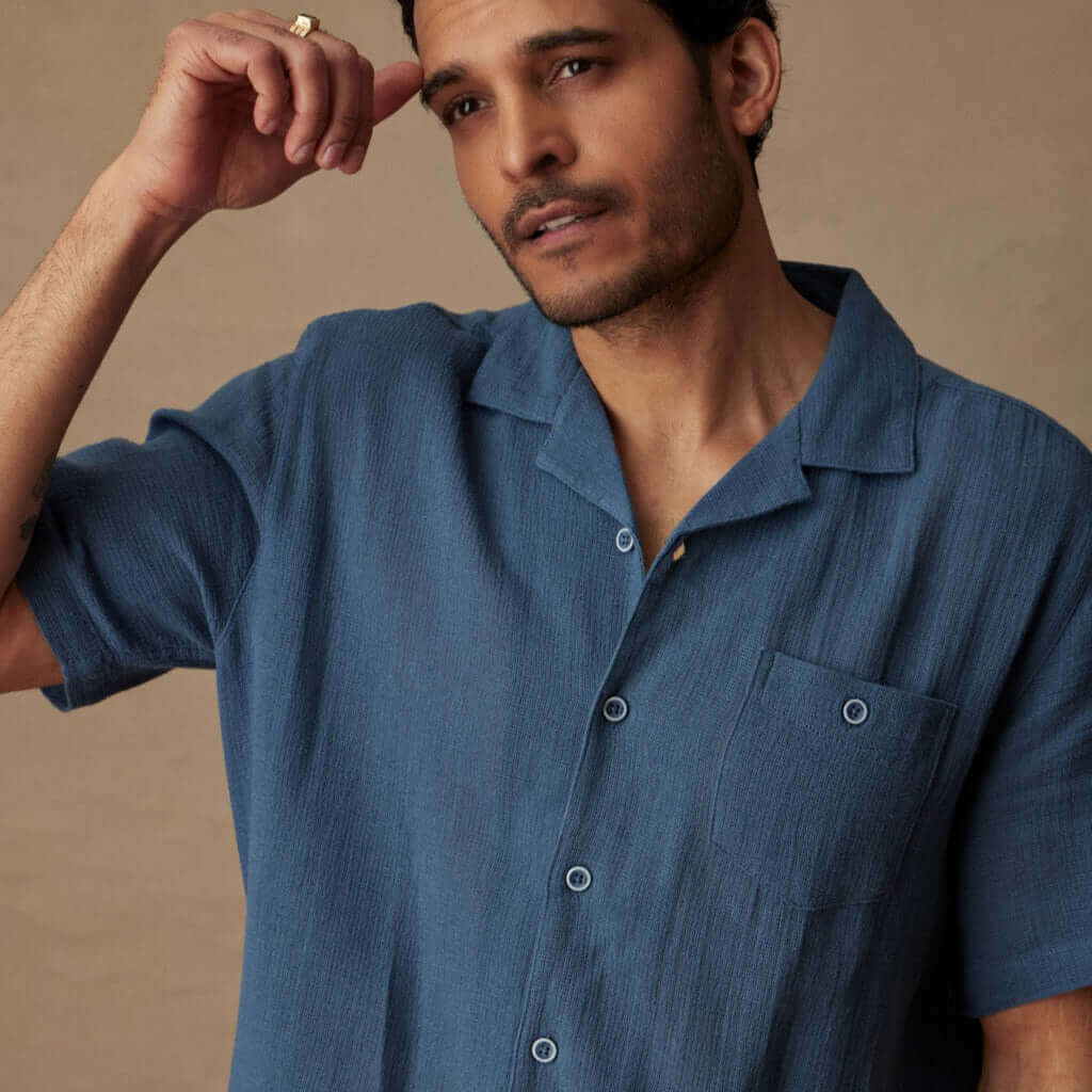 Short Sleeve Cotton Linen Airtex Shirt in Blue Ashes modeled by a man, showcasing classic vacation style and camp collar.