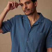 Short Sleeve Cotton Linen Airtex Shirt in Blue Ashes modeled by a man, showcasing classic vacation style and camp collar.