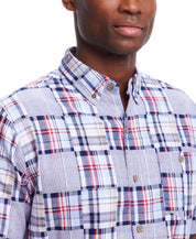 Close-up of a model wearing a Short Sleeve Cotton Patchwork Shirt In Icelandic Blue with a unique patchwork print.
