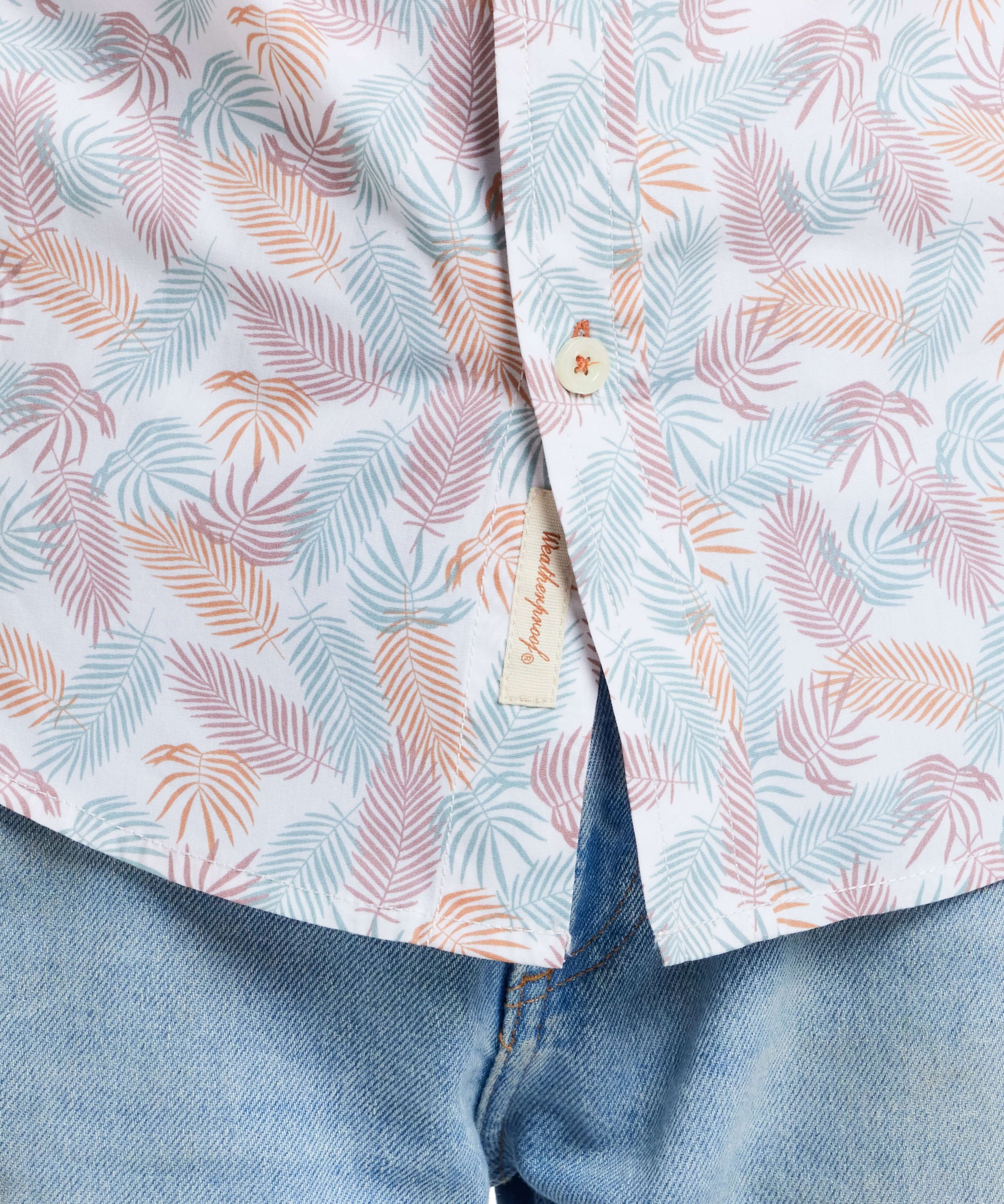 Lavender leaf patterned short sleeve cotton poplin shirt, showcasing classic tailoring and button detail, paired with denim.