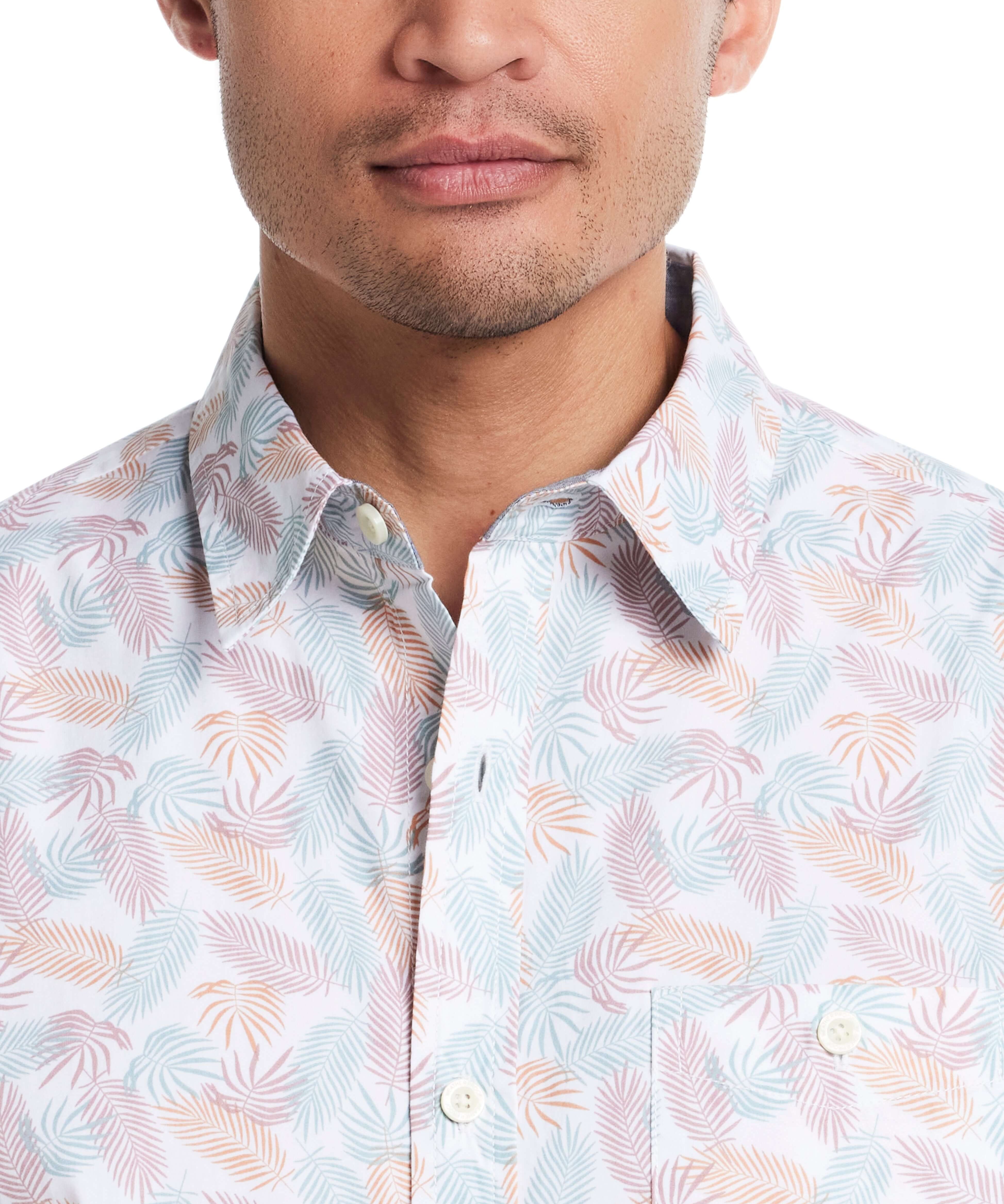 Close-up of a man wearing a lavender leaf patterned short sleeve cotton poplin shirt with a button-down collar.