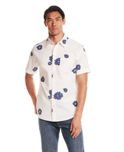 Short Sleeve Seersucker Print in Victoria Blue worn by a model, featuring a button front and point collar with floral print.