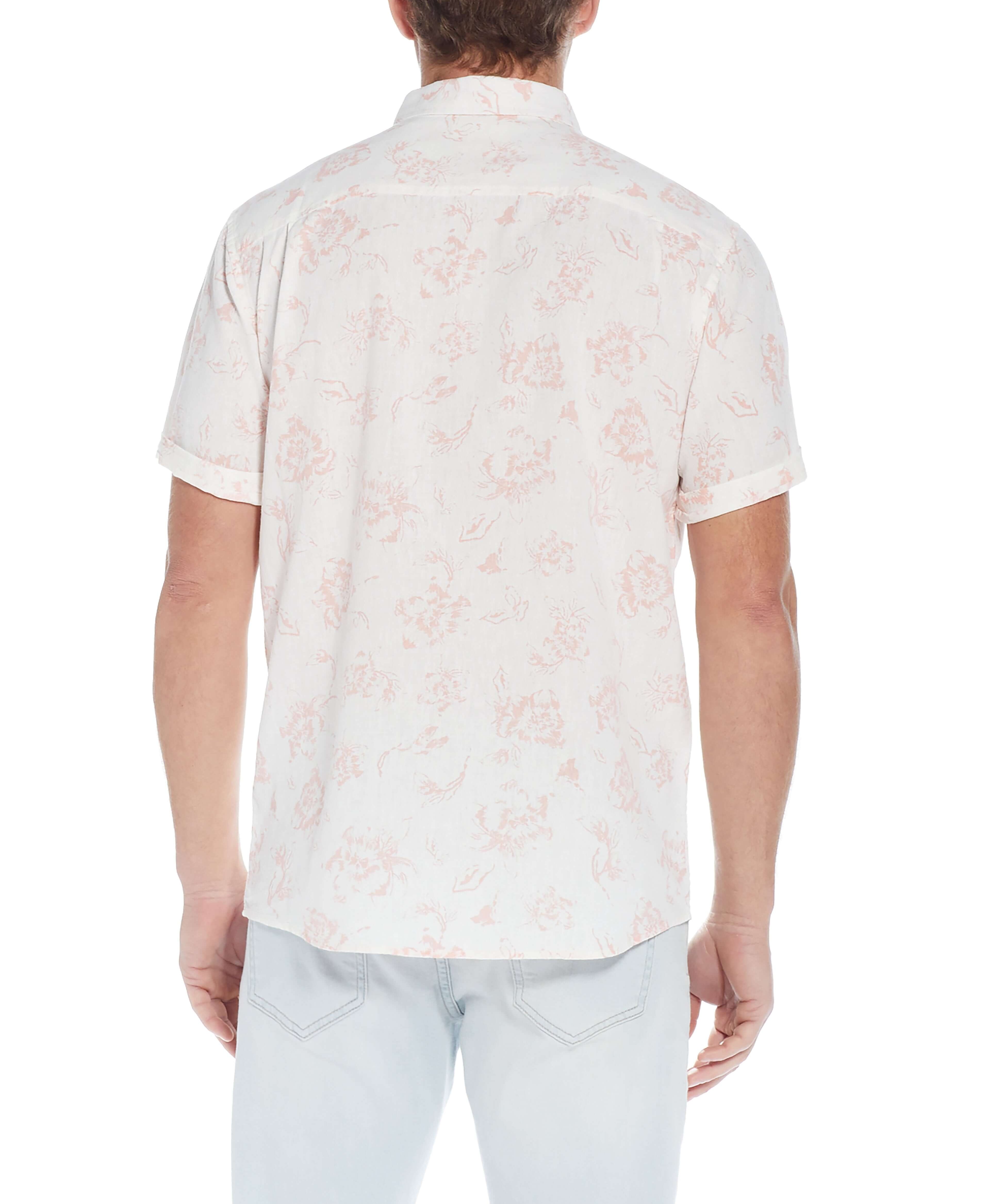 Back view of a man wearing a short sleeve floral shirt in pink, showcasing the relaxed fit and breezy linen cotton fabric.