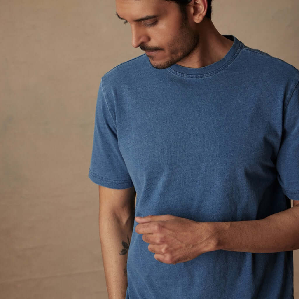 Model wearing a short sleeve indigo crew t-shirt made from soft slub cotton, designed for comfort and versatility.
