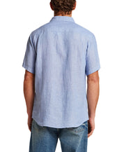 Back view of a man wearing a Short Sleeve Linen Shirt in Infinity Blue, showcasing its classic fit and linen fabric.