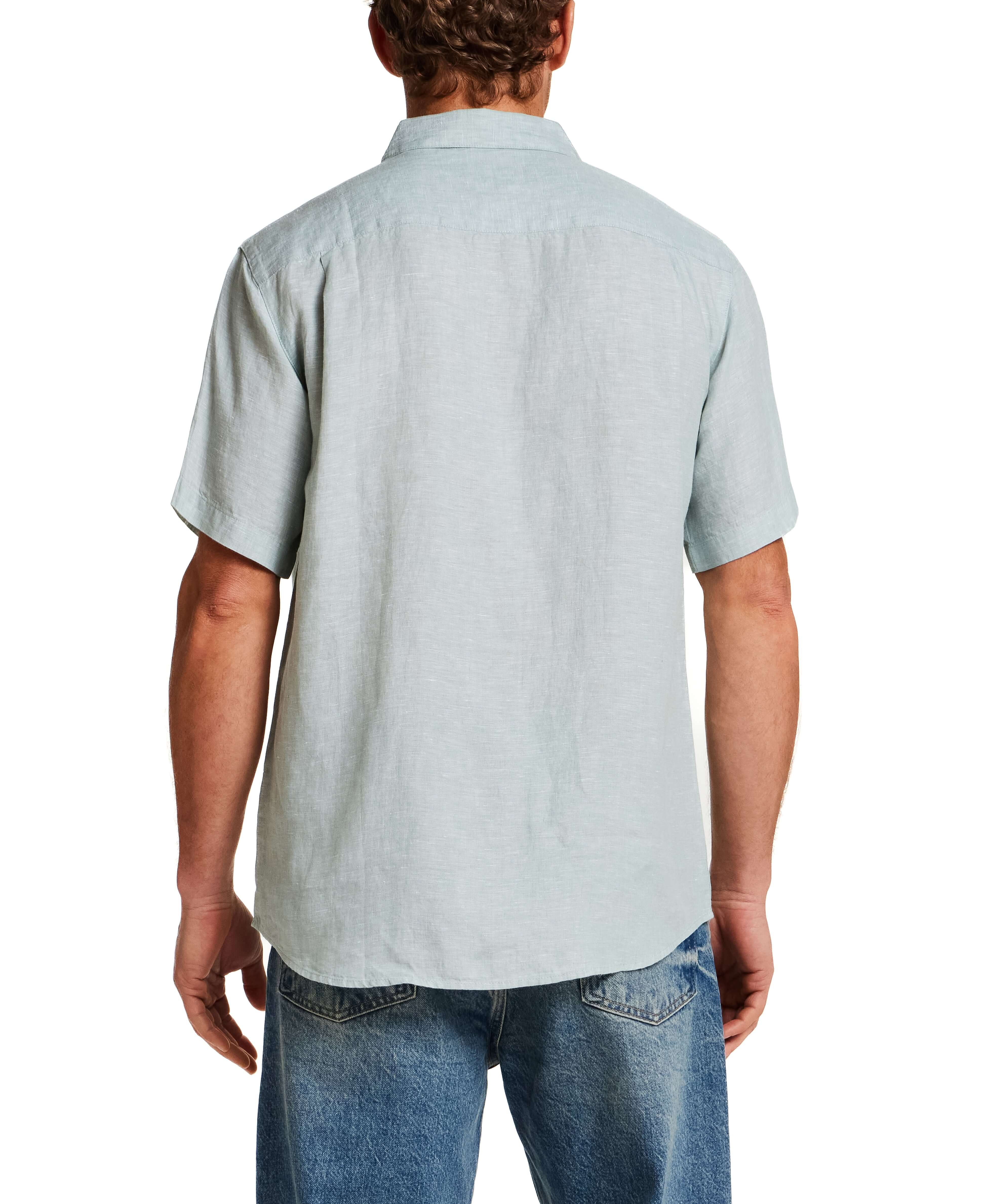 Back view of a man wearing a Short Sleeve Linen Shirt in Teal Mist, showcasing the classic fit and short sleeves.