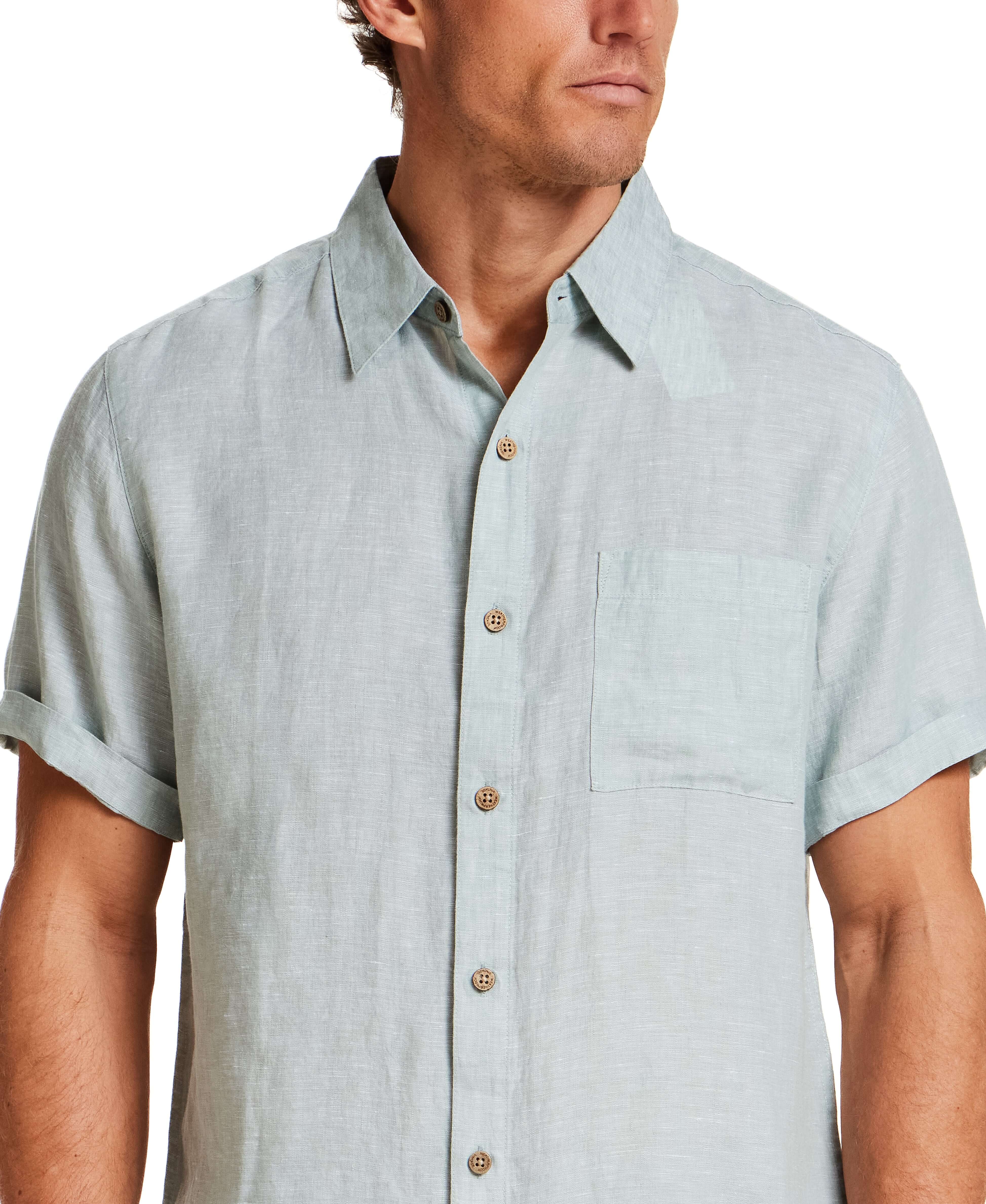 Short Sleeve Linen Shirt in Teal Mist worn by a man, featuring a spread collar and chest pocket.