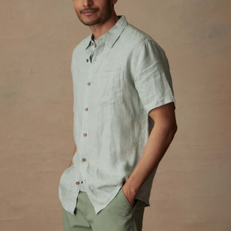 Short Sleeve Linen Shirt in Teal Mist model wearing a classic fit linen shirt with short sleeves and button closure.