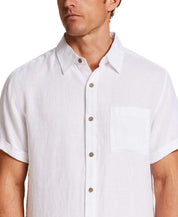 Short Sleeve Linen Shirt in White worn by model, featuring short sleeves and a chest pocket.