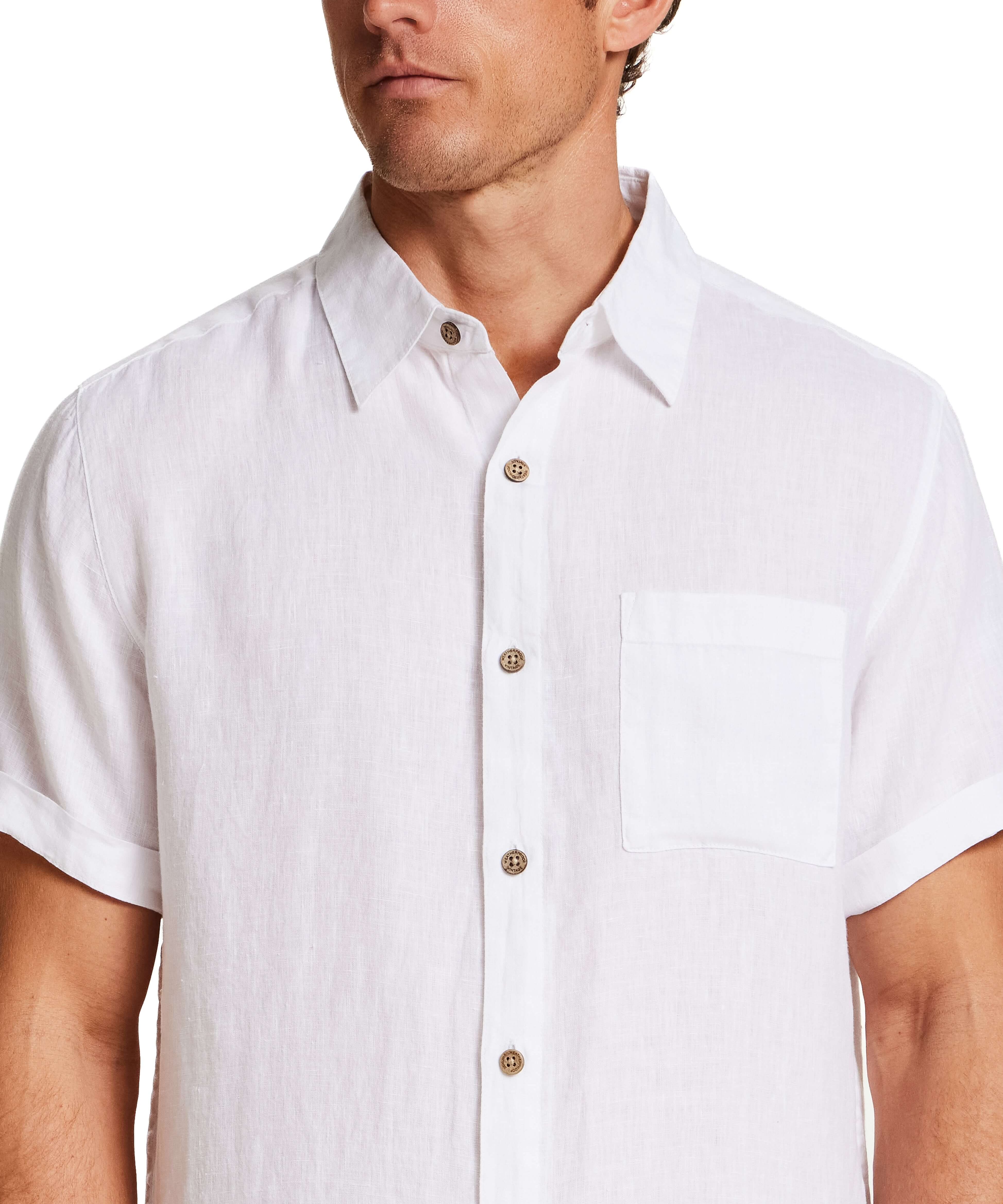 Short Sleeve Linen Shirt in White worn by model, featuring short sleeves and a chest pocket.