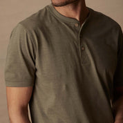 Men's olive short sleeve melange henley shirt featuring a 3 button placket and rib-knit neckline.