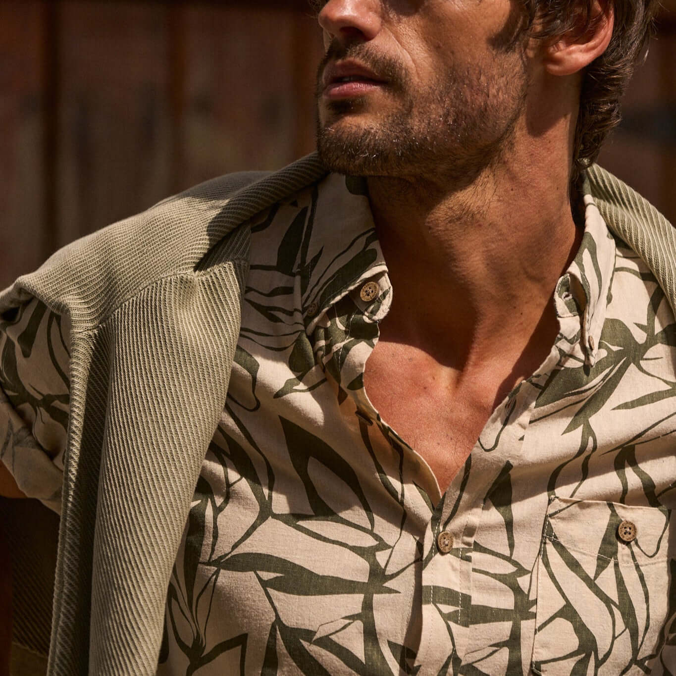 Model wearing a short sleeve print linen cotton shirt with an abstract leaf design, showcasing a relaxed fit and casual style.