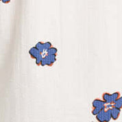 Close-up of the floral print in the Short Sleeve Seersucker Print in Victoria Blue shirt, featuring blue flowers on a textured background.