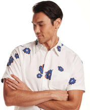 Short Sleeve Seersucker Print in Victoria Blue worn by a man, showcasing floral patterns on lightweight cotton.