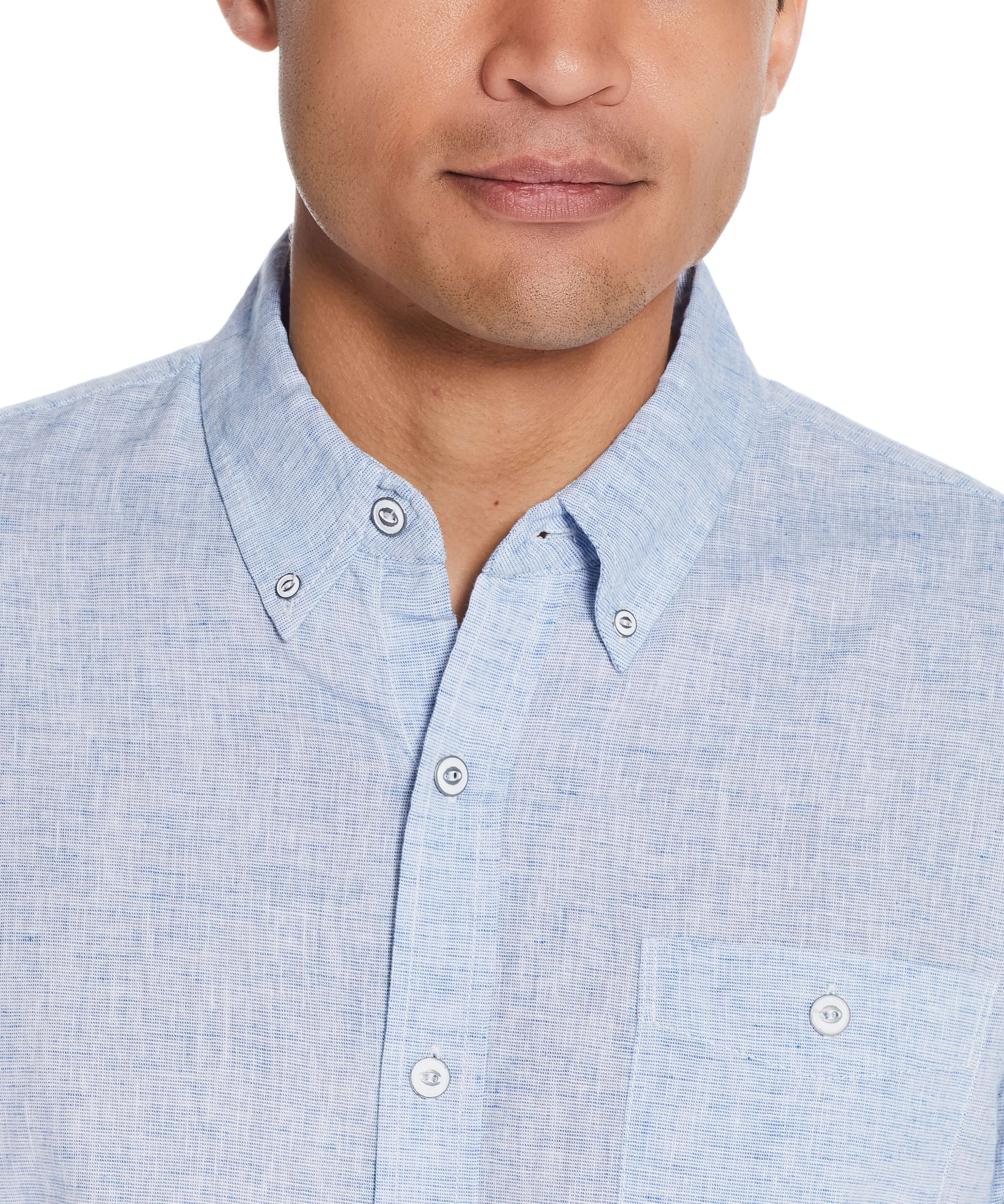 Close-up of a man wearing a short sleeve solid linen cotton shirt in Cendre Blue, featuring a button-down collar and pocket.