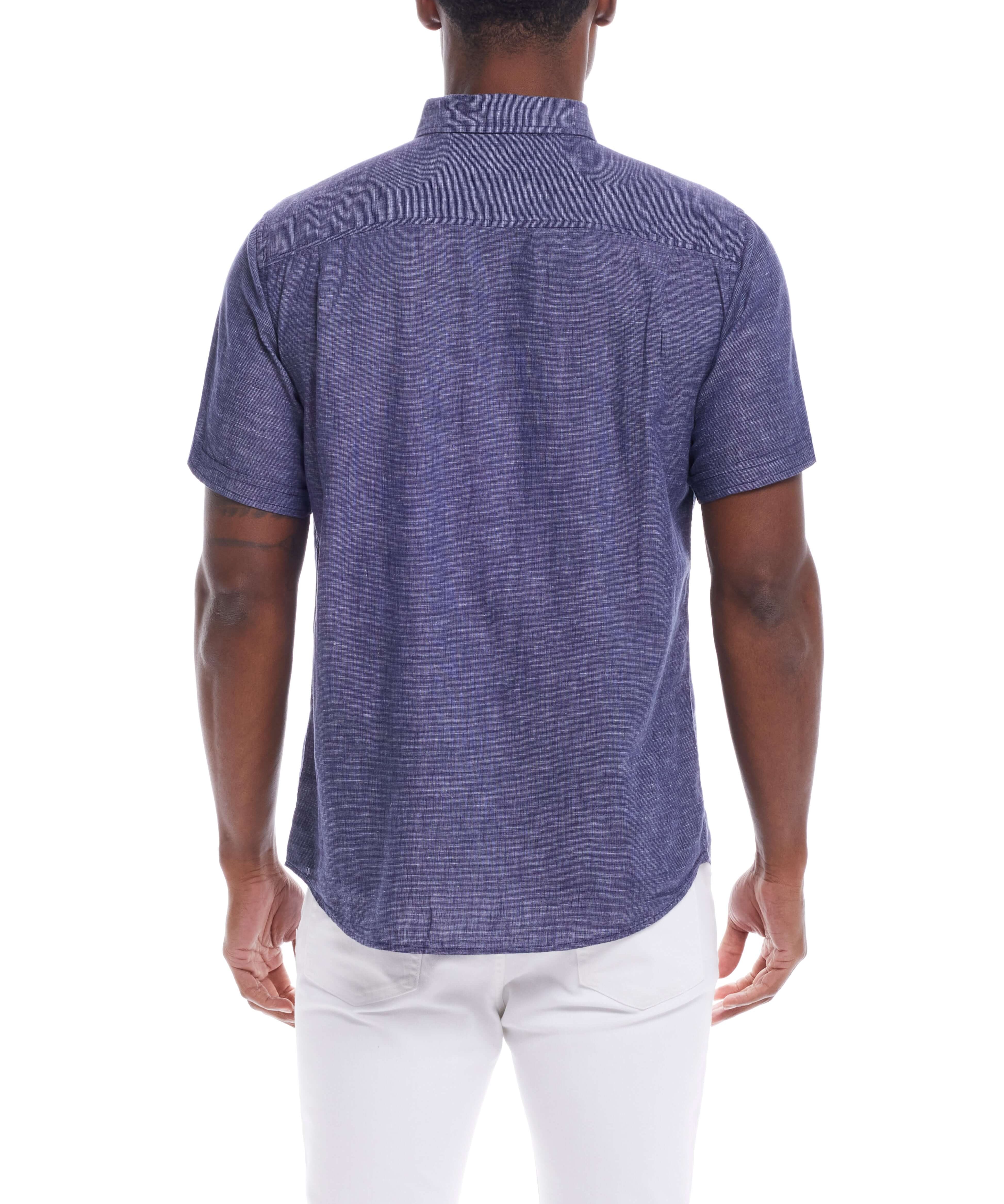Back view of a man wearing a short sleeve solid linen cotton shirt in Naval Academy color, styled for a relaxed look.