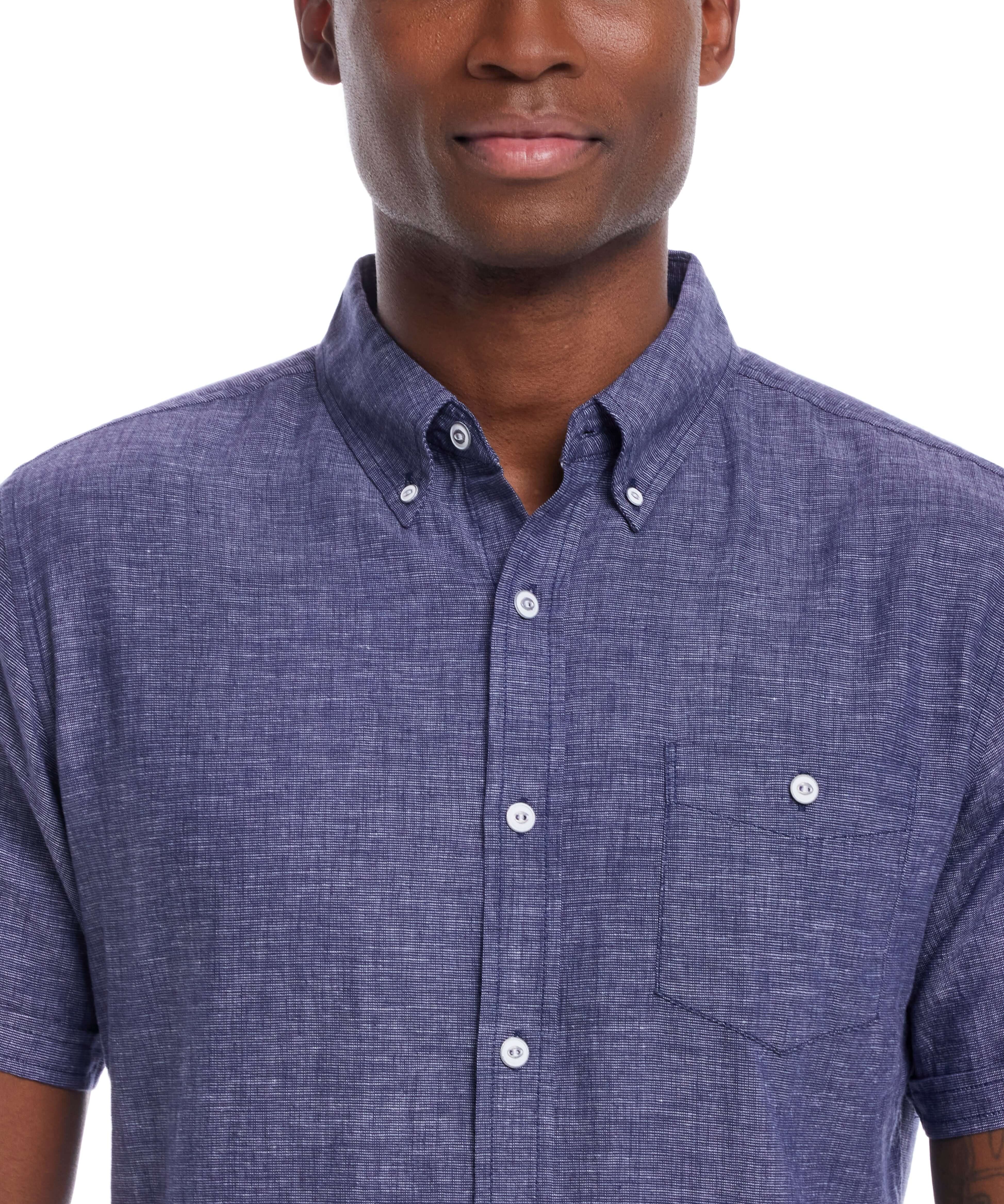 Close-up of a man wearing a short sleeve solid linen cotton shirt in a rich navy color, showcasing comfort and style.