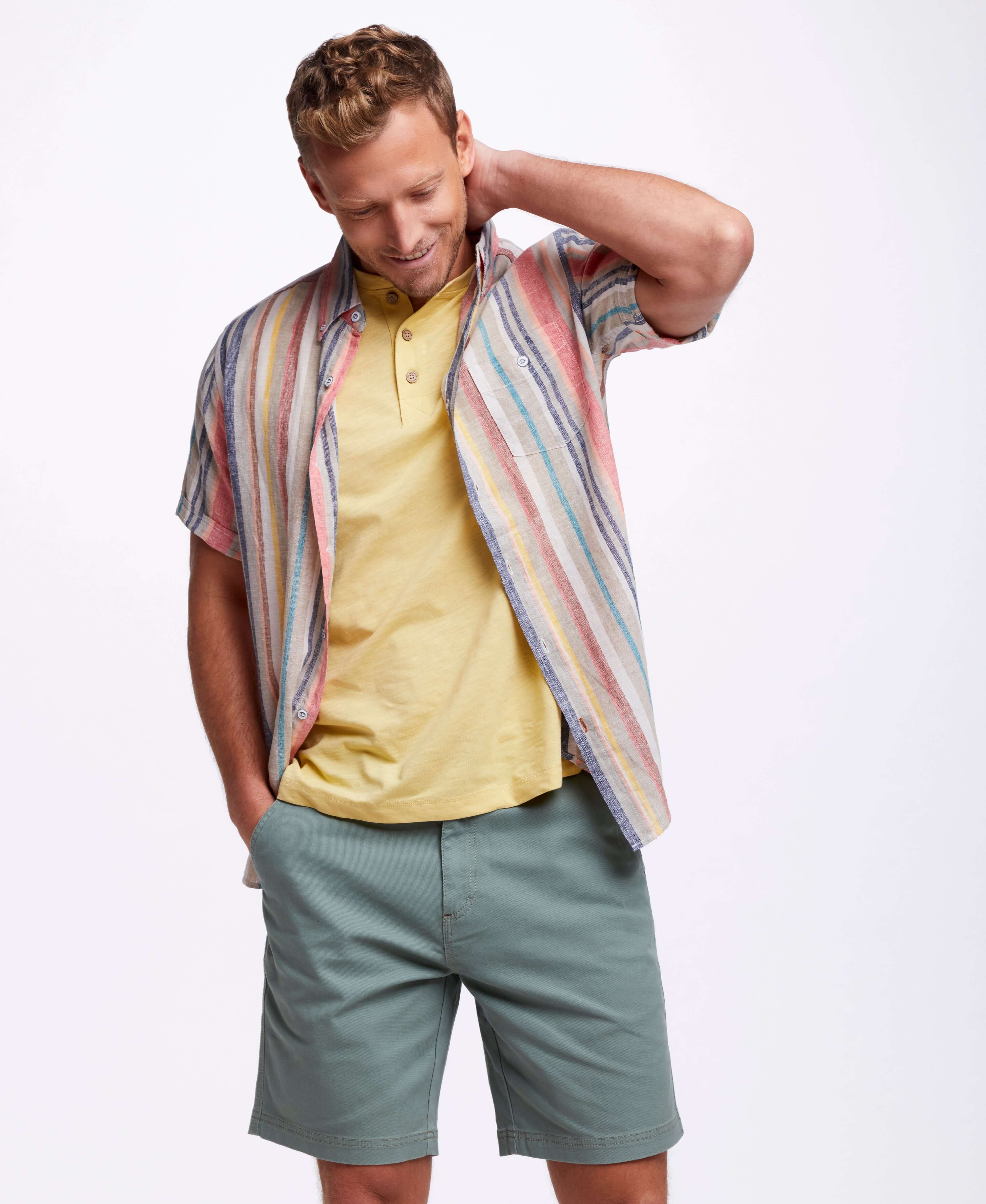 Model wearing Short Sleeve Stripe Linen Cotton Shirt In Peach Echo with relaxed fit and short sleeves.