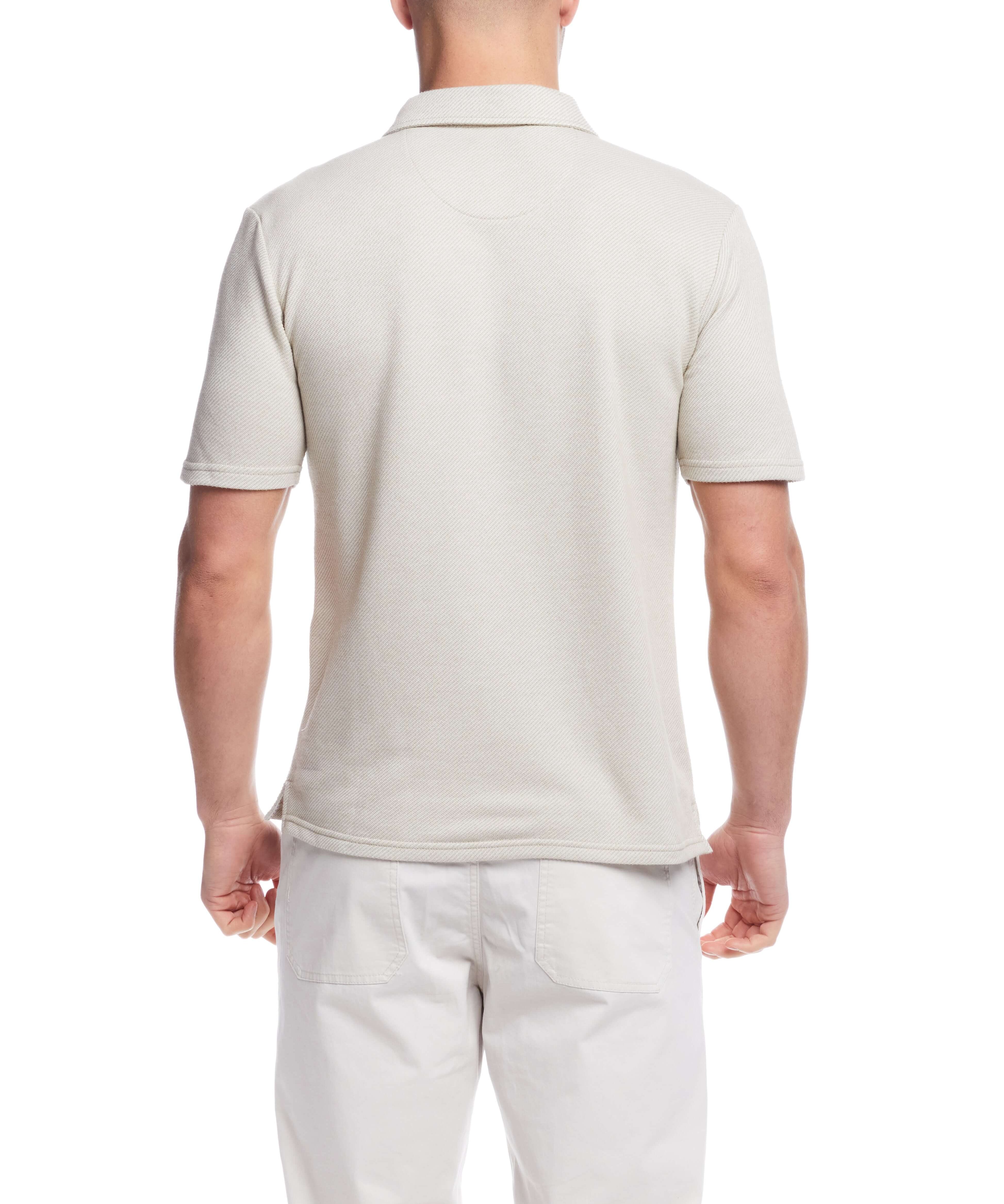 Back view of a man wearing a short sleeve twill polo shirt in natural color, featuring a classic design and regular fit.