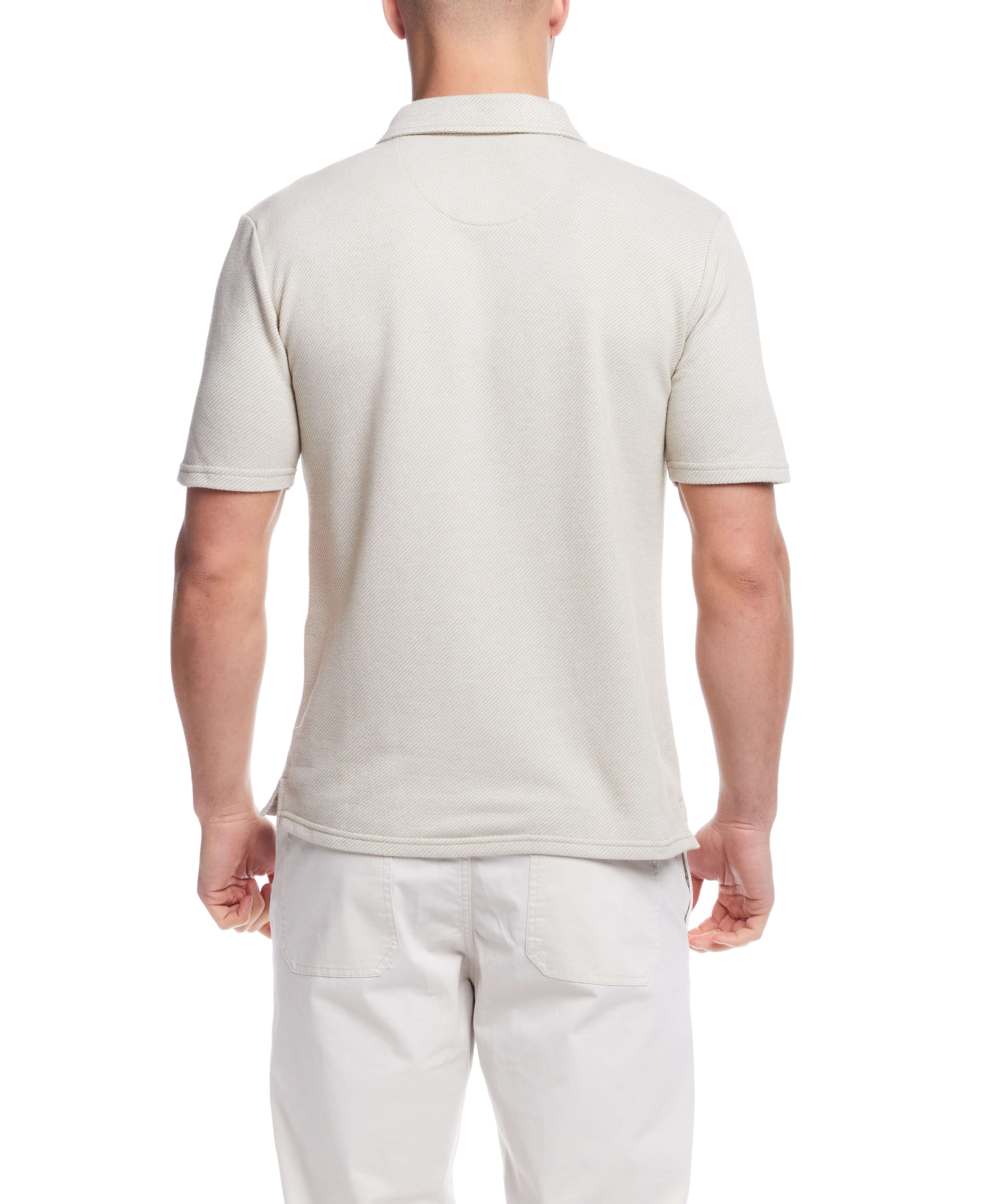 Back view of a man wearing a short sleeve twill polo shirt in natural color, featuring a classic design and regular fit.