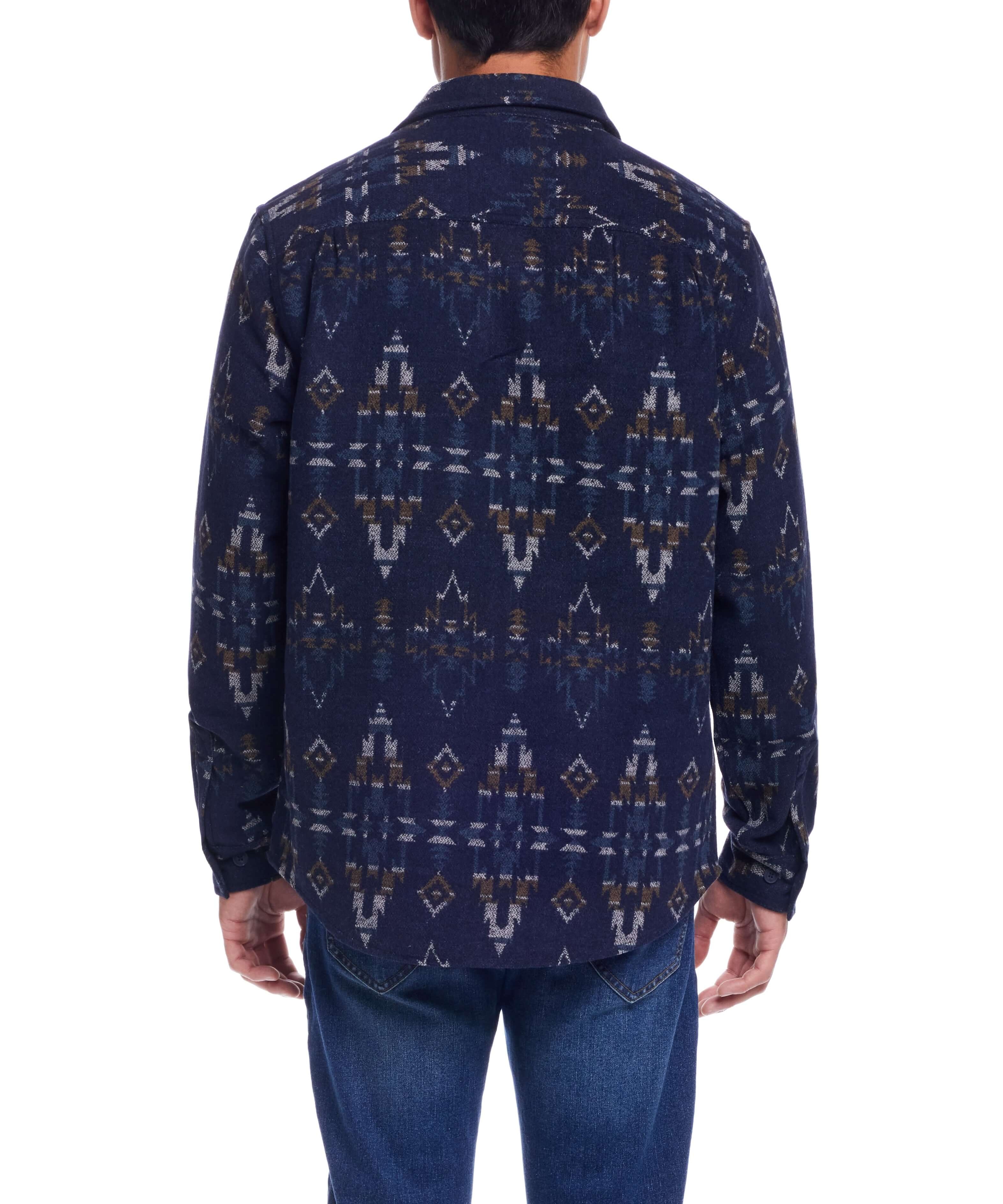 Back view of a man wearing a Southwest Jacquard Shirt Jacket in blue moss, showcasing the intricate southwestern pattern.