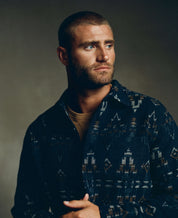 Model wearing a Southwest jacquard shirt jacket in blue moss, showcasing southwestern patterns and style.