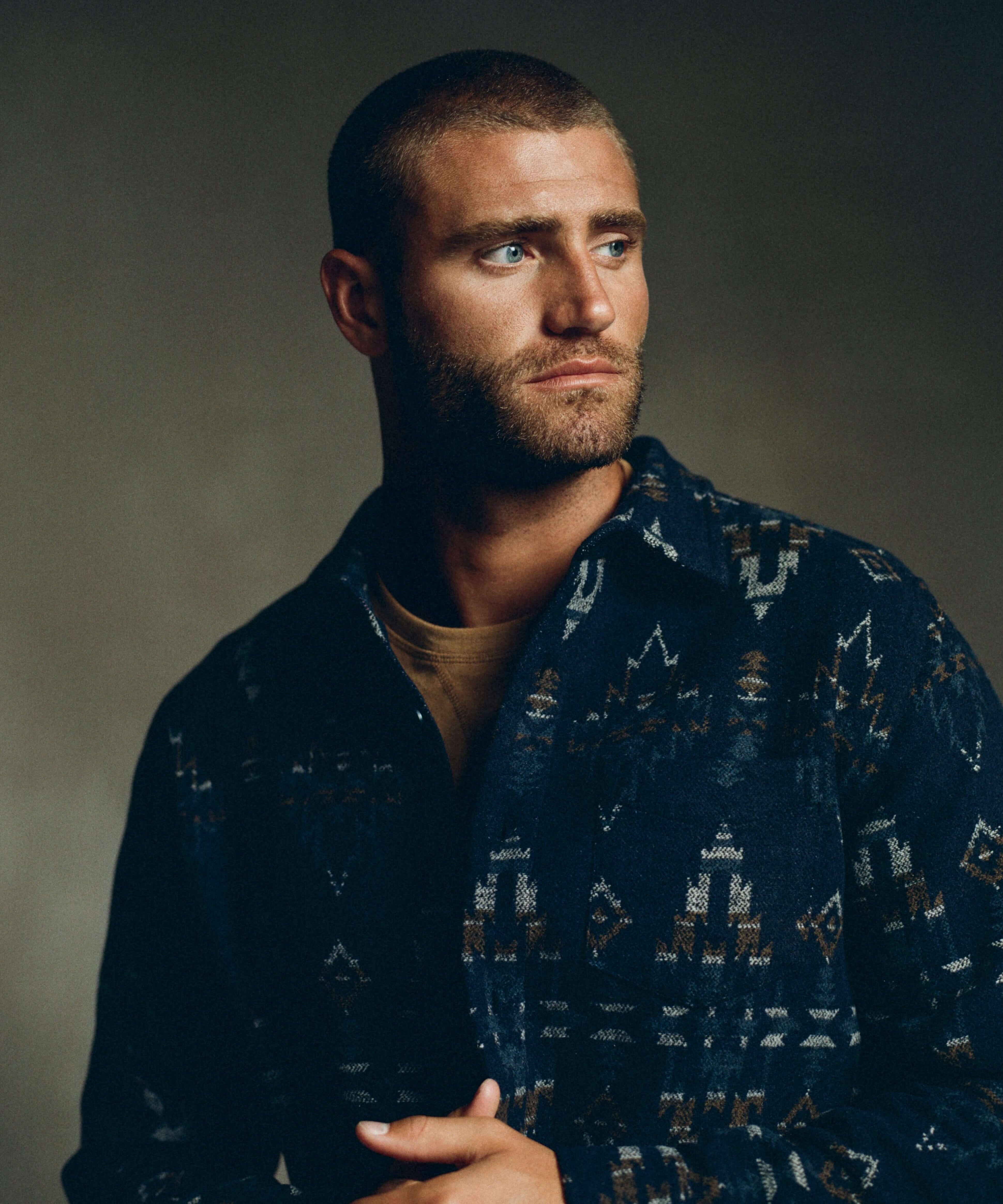 Model wearing a Southwest jacquard shirt jacket in blue moss, showcasing southwestern patterns and style.