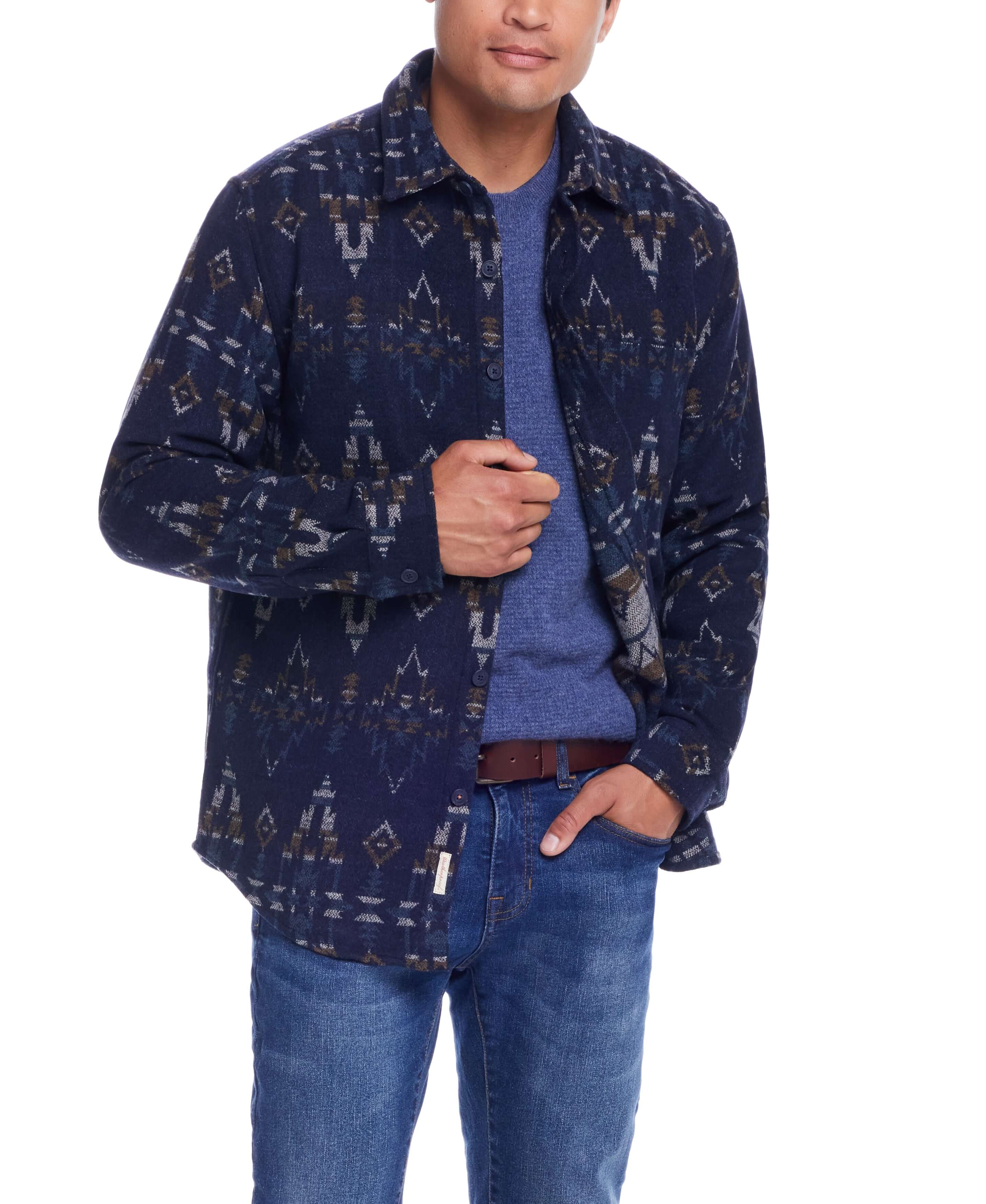 Model wearing a Southwest Jacquard Shirt Jacket in Blue Moss, featuring southwestern-inspired patterns, paired with blue jeans.