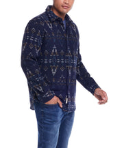 Man modeling a Southwest jacquard shirt jacket in blue moss, featuring a stylish southwestern pattern with blue jeans.