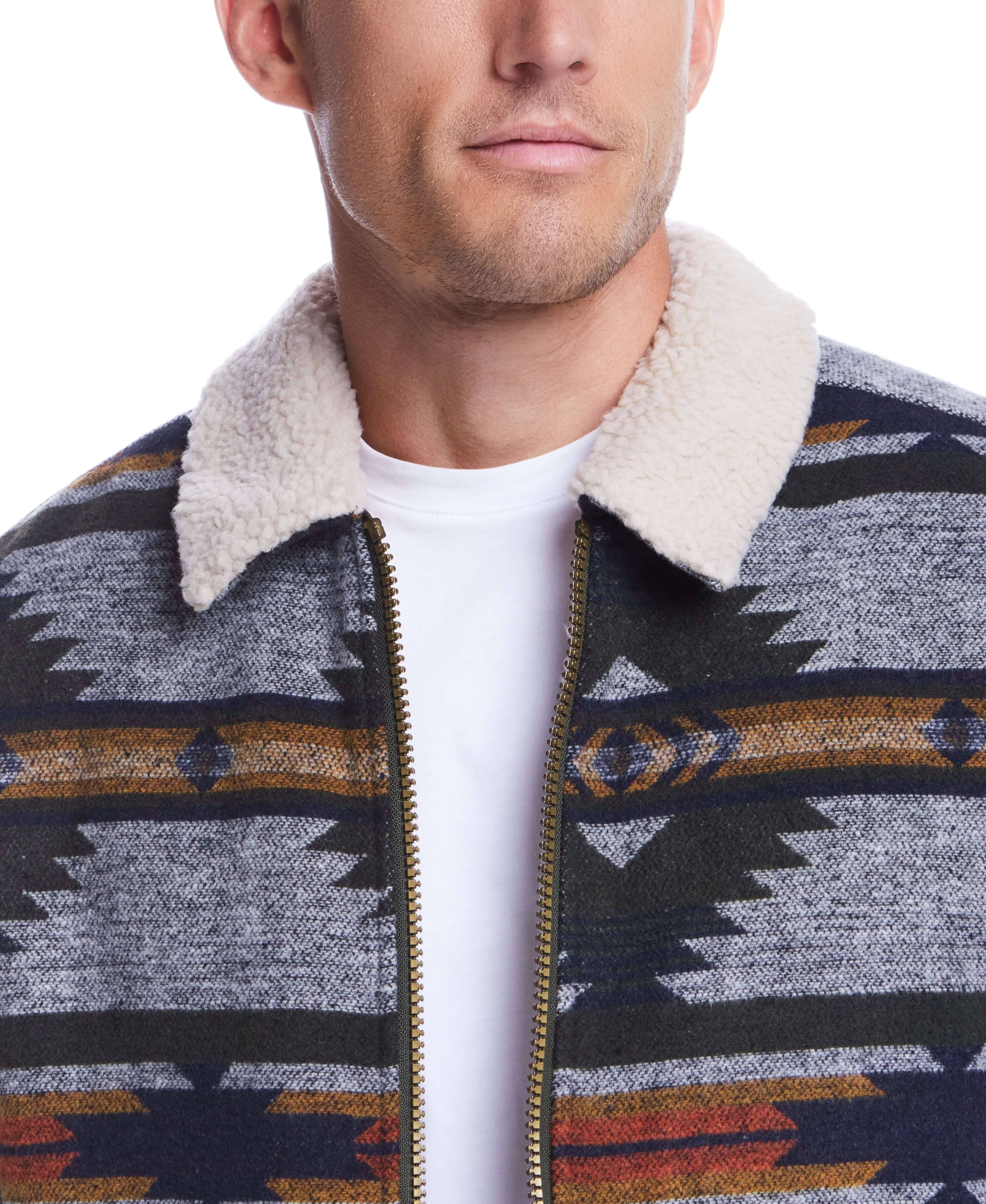 Close-up of a man in a southwestern-inspired sherpa-lined jacket with geometric print.